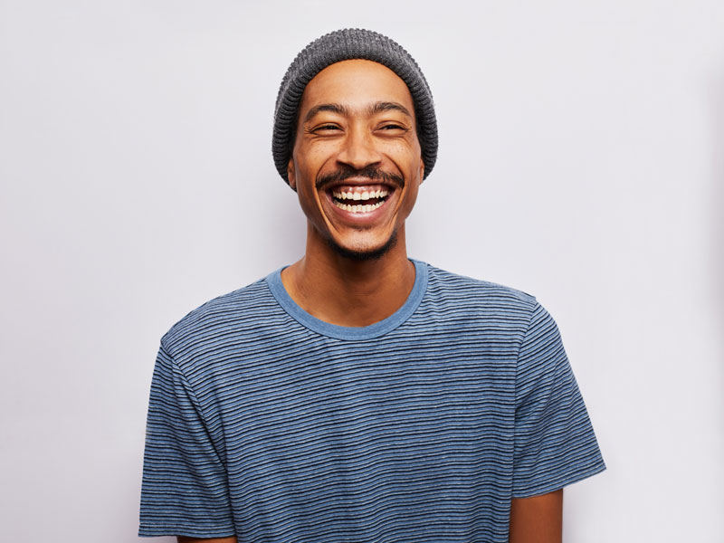 man in hat laughing